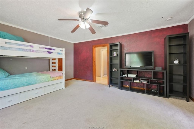 carpeted bedroom with ceiling fan, a textured ceiling, and crown molding