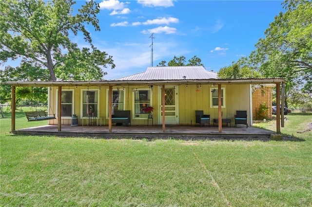 back of property with a lawn