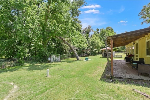 view of yard with a wooden deck, a gazebo, and an outdoor living space