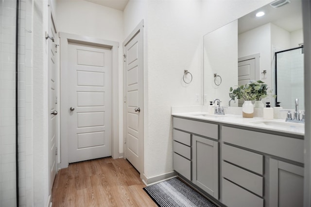 bathroom with vanity, hardwood / wood-style floors, and an enclosed shower