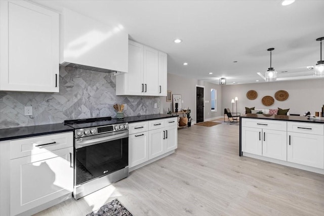 kitchen featuring decorative light fixtures, light hardwood / wood-style floors, electric range, and white cabinets