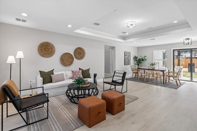 6003 Libyan Dr, Austin, TX 78745 - living area featuring a tray ceiling, light wood-style flooring, baseboards, and recessed lighting