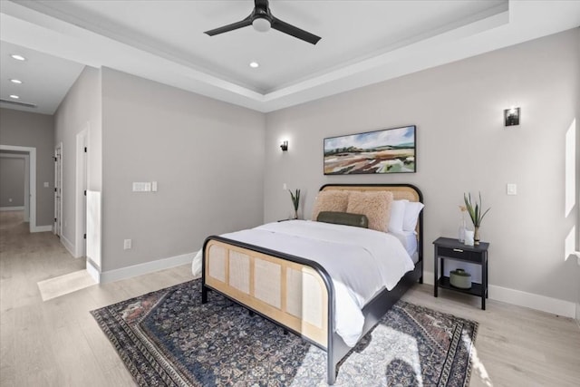 6003 Libyan Dr, Austin, TX 78745 - bedroom with recessed lighting, light wood-style floors, baseboards, a tray ceiling, and ceiling fan