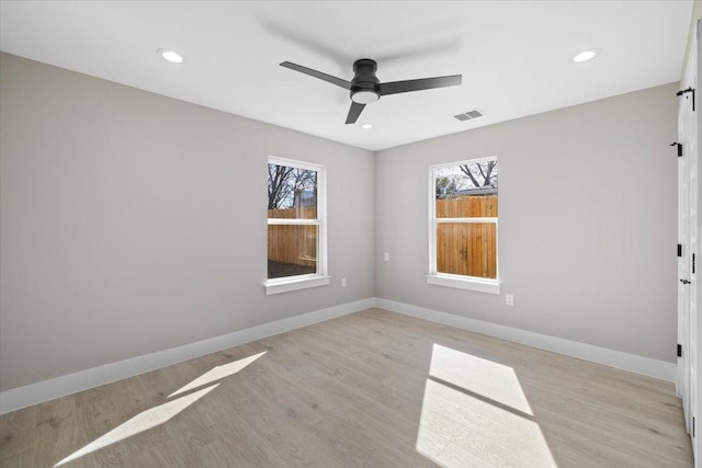 spare room with ceiling fan and light hardwood / wood-style floors