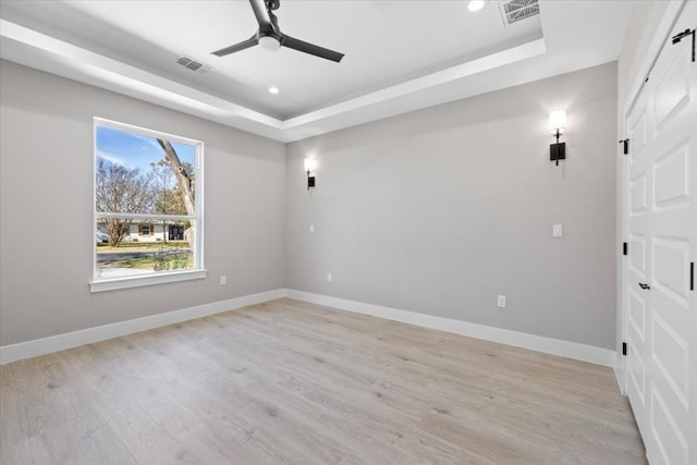 6003 Libyan Dr, Austin, TX 78745 - empty room featuring a tray ceiling, a ceiling fan, light wood finished floors, baseboards, and recessed lighting