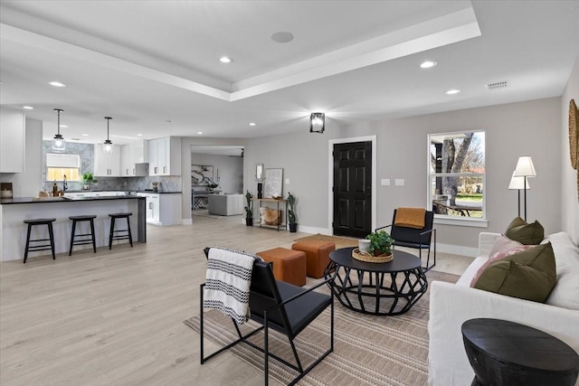 living room featuring sink and light wood-type flooring