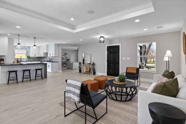 6003 Libyan Dr, Austin, TX 78745 - living room with plenty of natural light, recessed lighting, light wood-type flooring, baseboards, and a tray ceiling