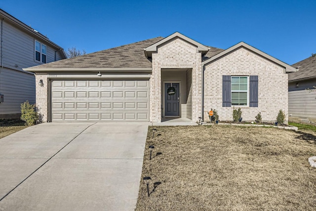 view of front of property featuring a garage and a front yard