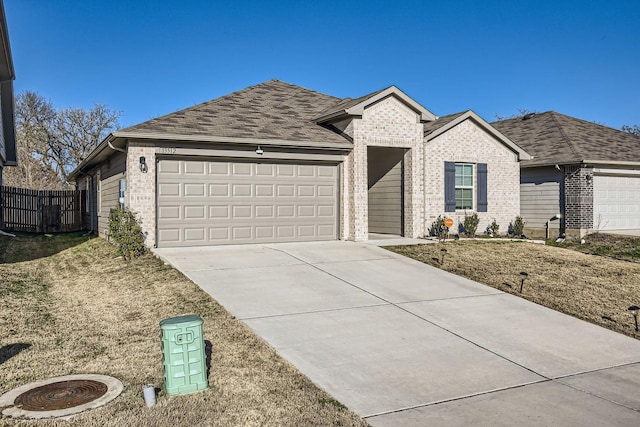 ranch-style home with a garage and a front yard