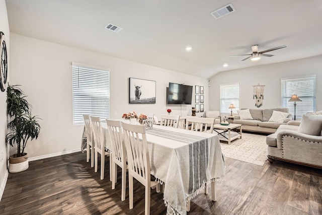 dining space with vaulted ceiling, dark hardwood / wood-style floors, and ceiling fan