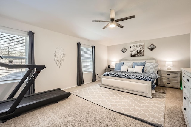 bedroom with ceiling fan and light carpet