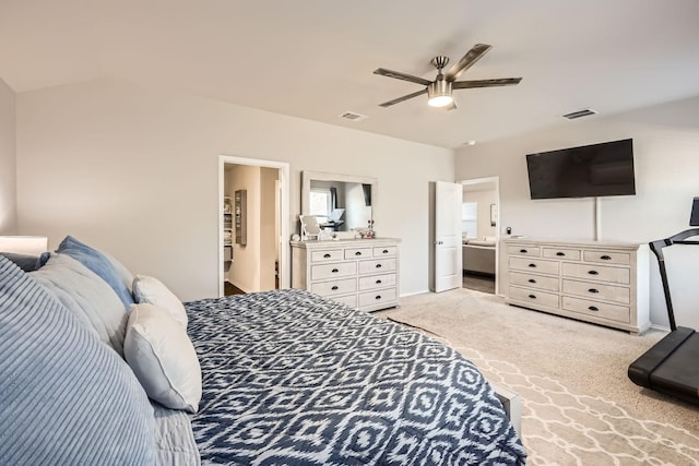 bedroom featuring light colored carpet, ceiling fan, and ensuite bathroom