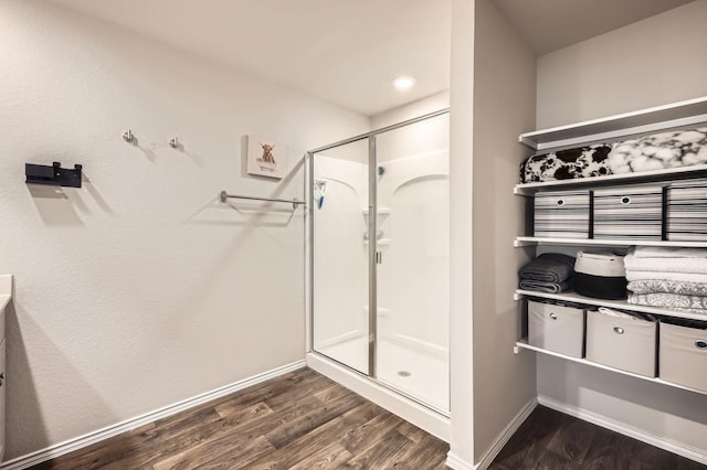 bathroom featuring hardwood / wood-style flooring and a shower with shower door