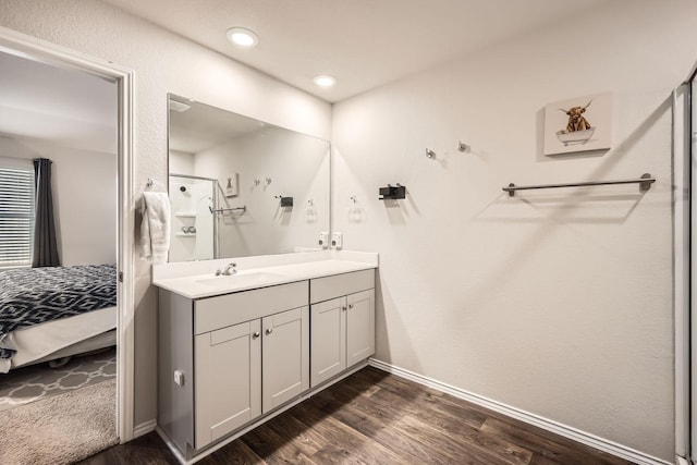 bathroom featuring walk in shower, wood-type flooring, and vanity