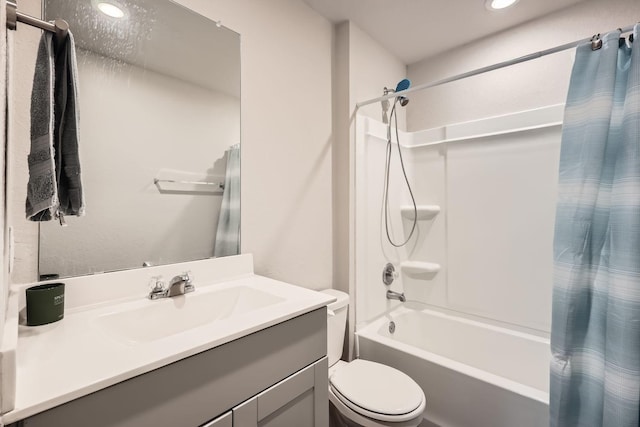 full bathroom featuring shower / tub combo with curtain, vanity, and toilet