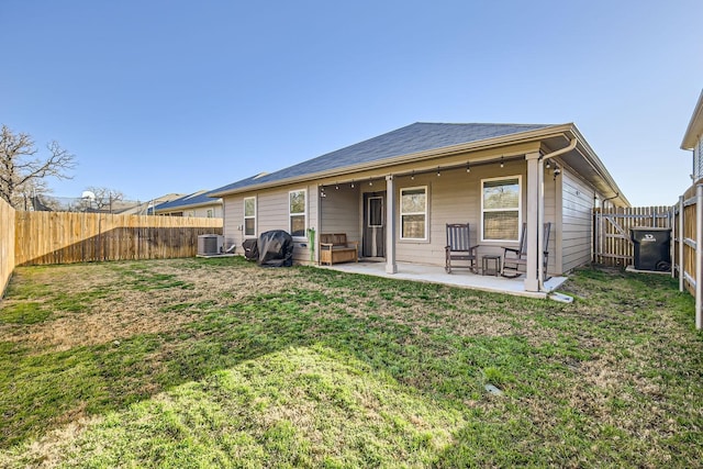 back of house with a lawn, a patio, and central air condition unit