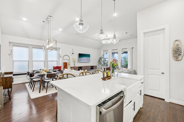 kitchen with stainless steel dishwasher, decorative light fixtures, sink, white cabinetry, and a center island with sink