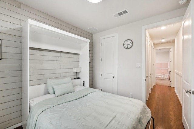 bedroom featuring dark hardwood / wood-style flooring and a closet