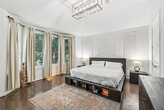 bedroom with dark hardwood / wood-style floors, a notable chandelier, and vaulted ceiling