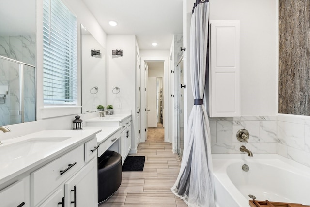 bathroom featuring plus walk in shower and vanity