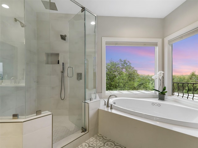 full bath featuring a garden tub and a shower stall