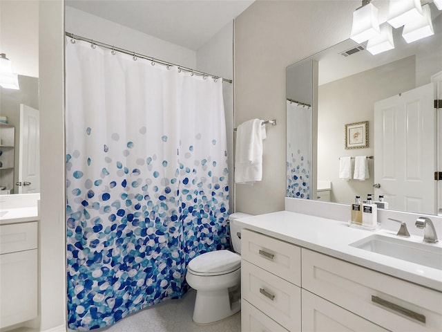 bathroom featuring tile patterned floors, toilet, and vanity