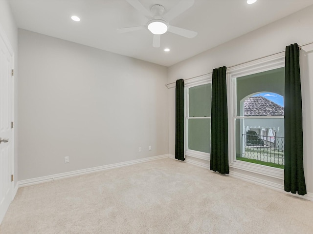 carpeted spare room featuring recessed lighting, baseboards, and ceiling fan