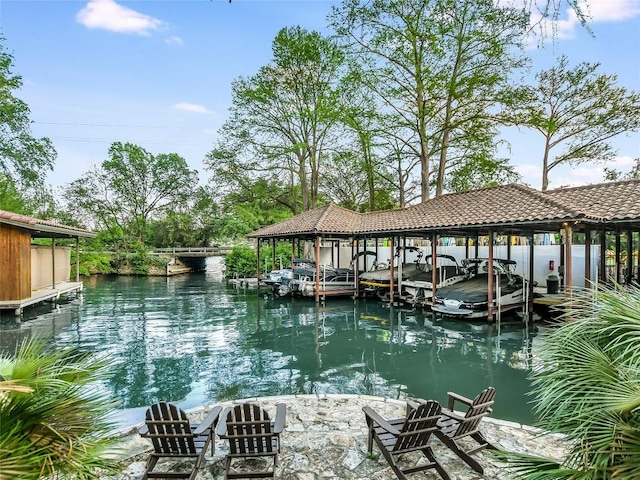 dock area with boat lift and a water view