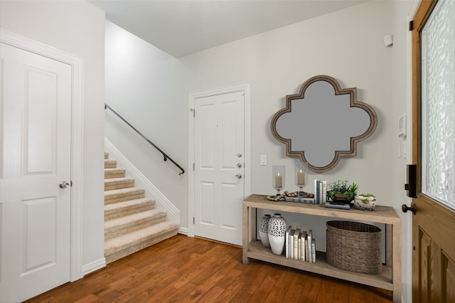 foyer featuring stairway and wood finished floors