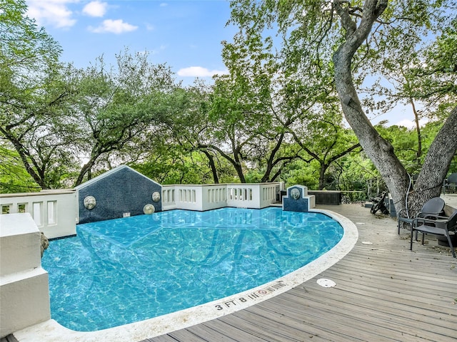 view of swimming pool featuring a wooden deck