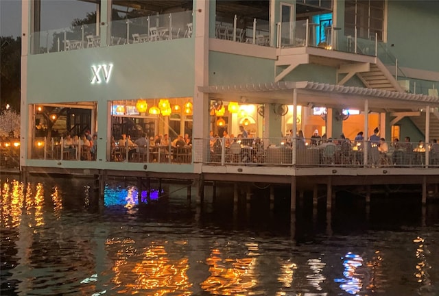 exterior space featuring a water view and a pergola