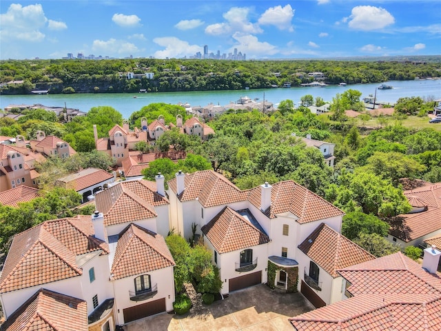 drone / aerial view with a residential view and a water view