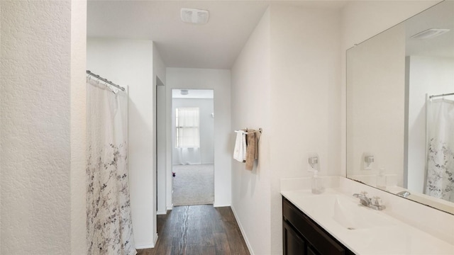 bathroom with vanity and hardwood / wood-style floors