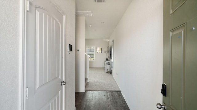 corridor with dark hardwood / wood-style flooring