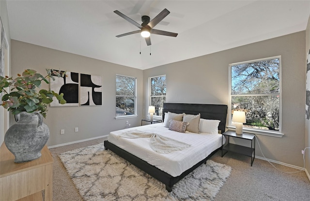 bedroom featuring ceiling fan and carpet