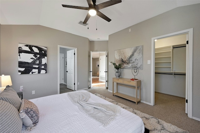 carpeted bedroom with a closet, ceiling fan, a spacious closet, and lofted ceiling