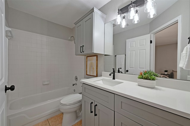 full bathroom with tiled shower / bath combo, tile patterned floors, vanity, and toilet