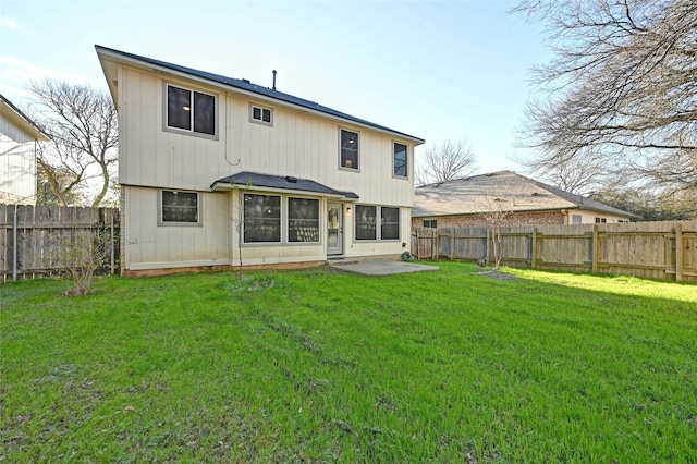 back of house with a yard and a patio