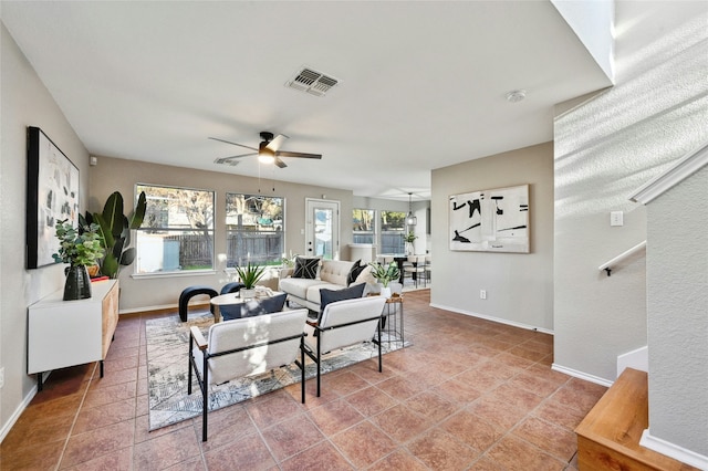 living room with ceiling fan and tile patterned flooring