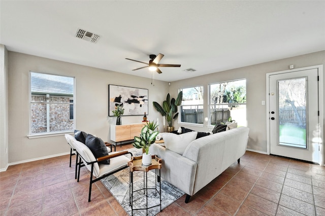 tiled living room featuring ceiling fan and a wealth of natural light