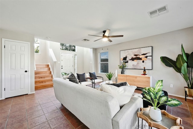 tiled living room with ceiling fan