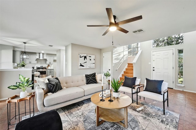 living room featuring light tile patterned floors and ceiling fan