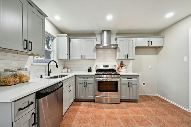 kitchen with appliances with stainless steel finishes, sink, wall chimney exhaust hood, gray cabinets, and light tile patterned flooring