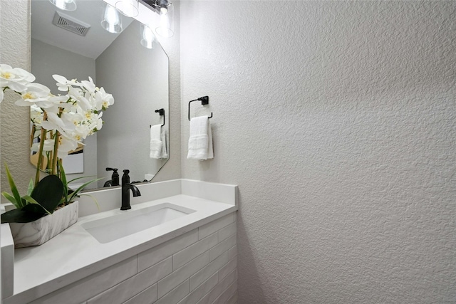 9504 Sanford Dr, Austin, TX 78748 - bathroom with vanity and a textured wall