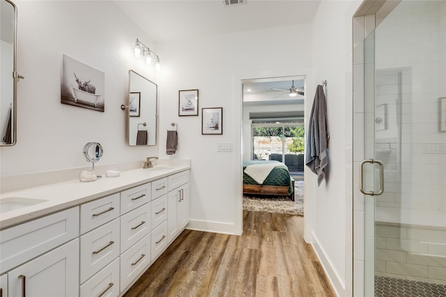 bathroom with vanity, an enclosed shower, and wood-type flooring