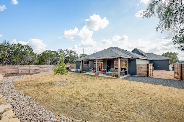 back of property with a patio and a yard