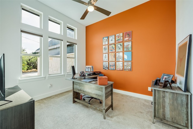 carpeted home office featuring ceiling fan