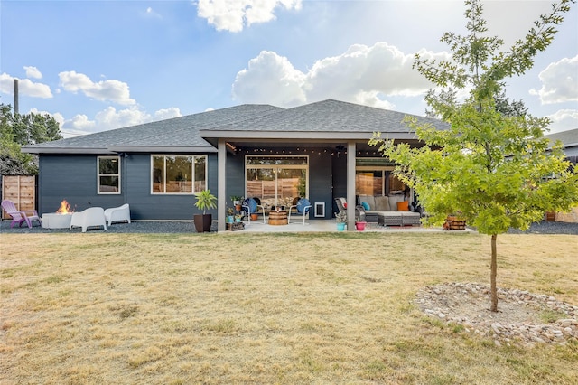 rear view of property featuring a yard, outdoor lounge area, and a patio