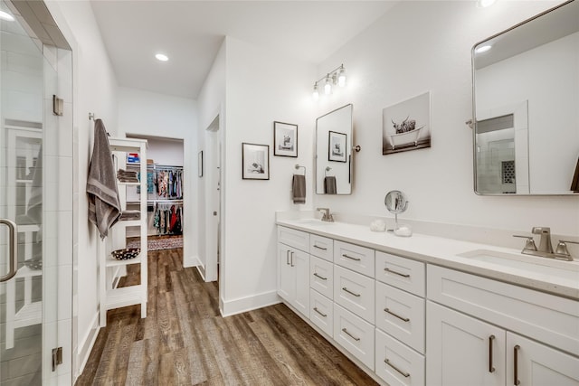 bathroom featuring hardwood / wood-style flooring, an enclosed shower, and vanity