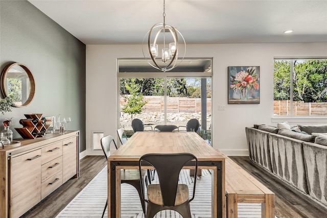 dining area featuring dark hardwood / wood-style floors and an inviting chandelier